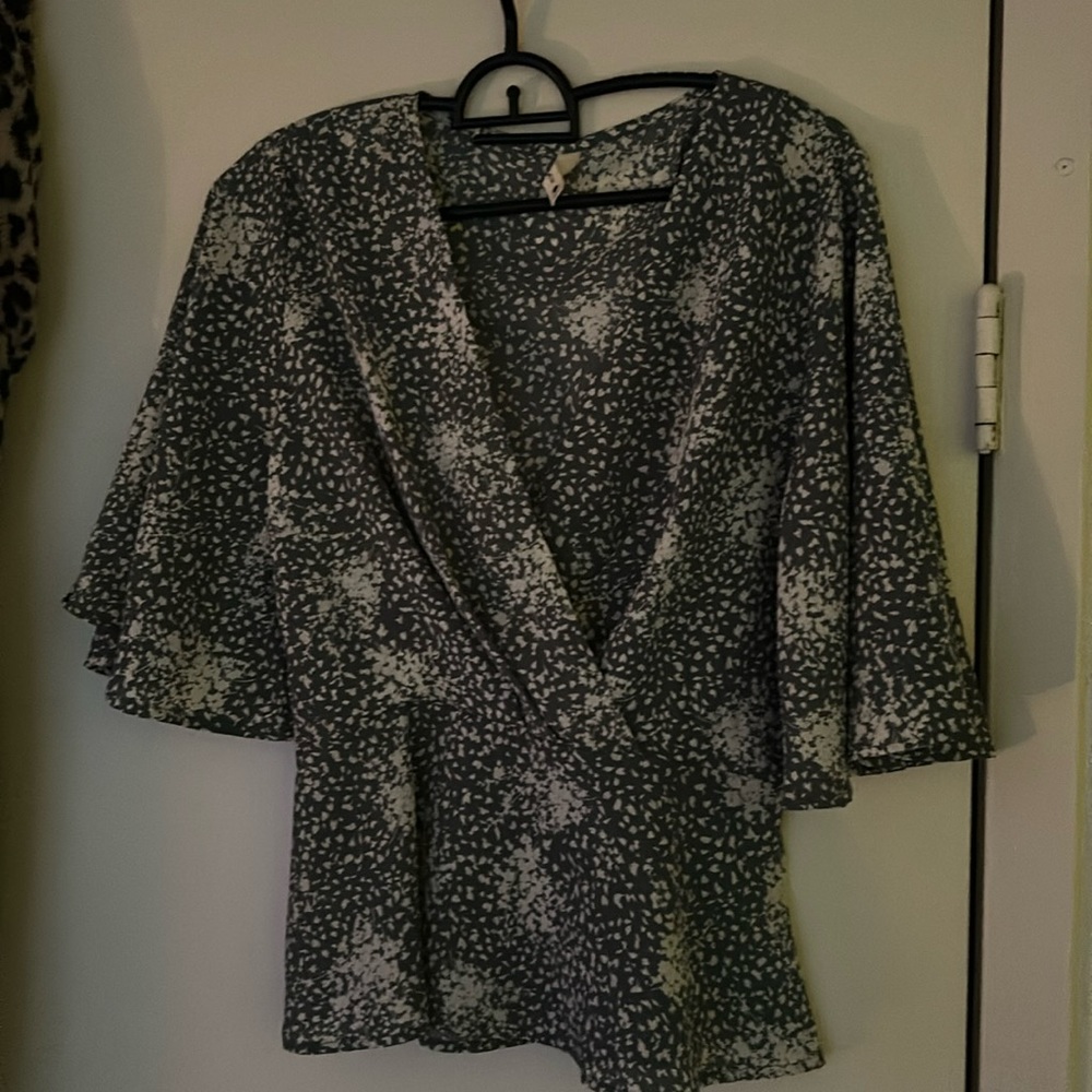 Green and white floral blouse